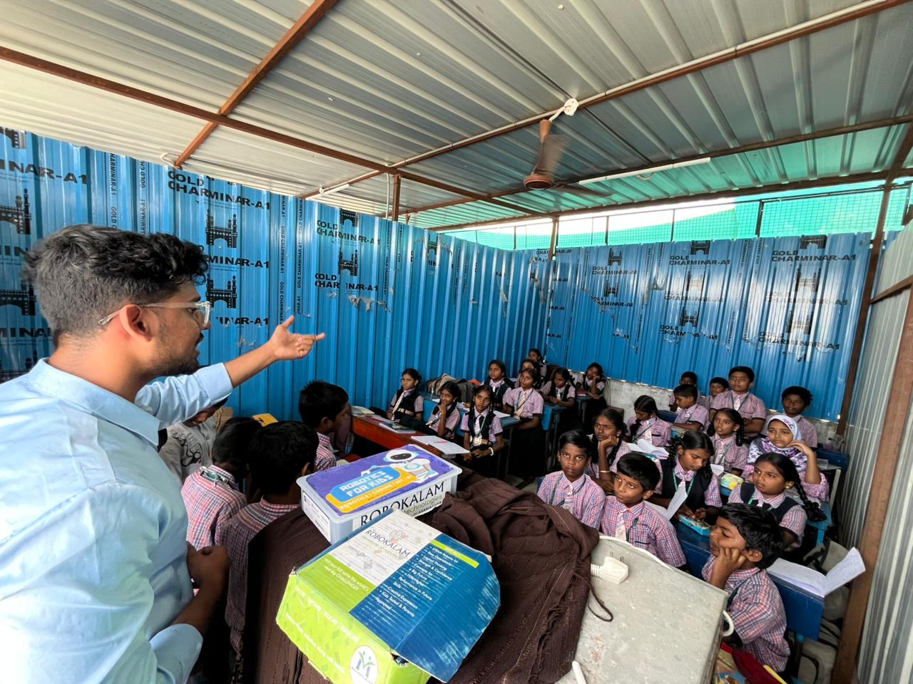 A Nxtera trainer presenting a robotics lesson to students in the 21C Lab classroom